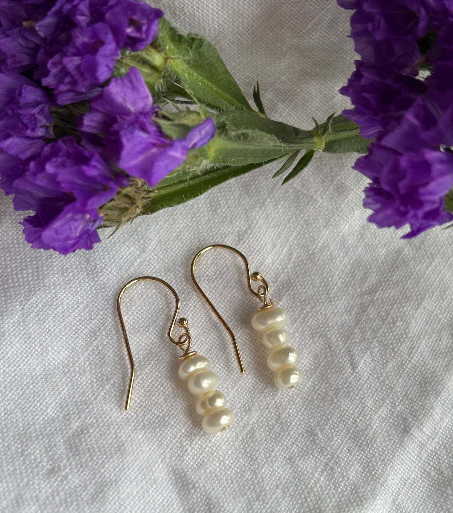 14K gold filled shepherd’s crook earring featuring white seed freshwater pearls