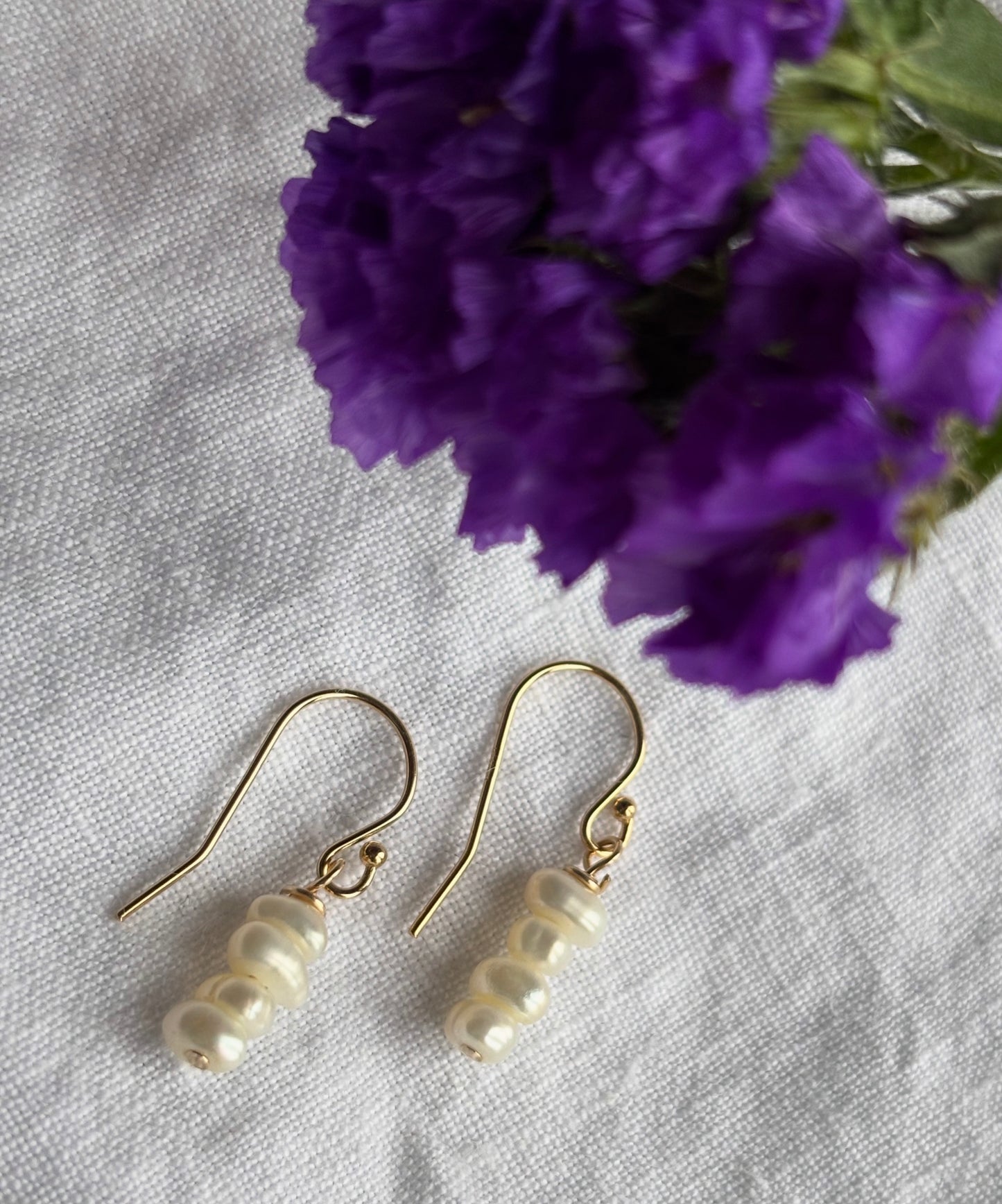 14K gold filled shepherd’s crook earring featuring white seed freshwater pearls